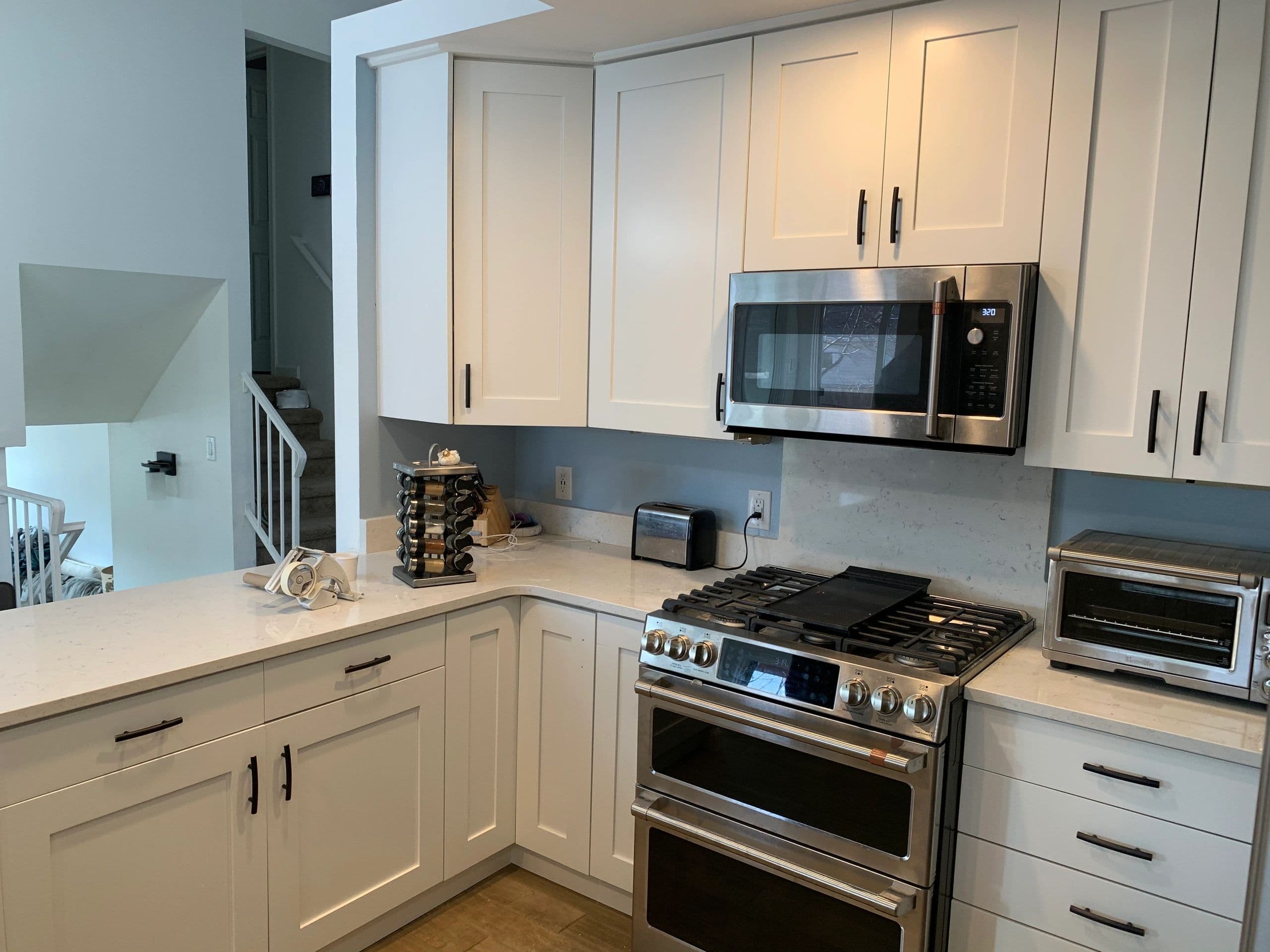 White shaker cabinets with black bar pulls and quartz counters